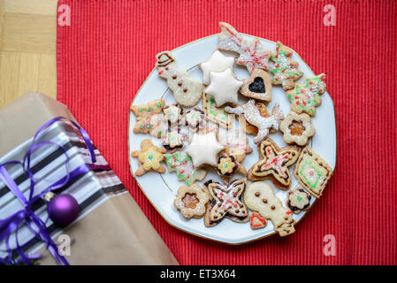 Hochwinkelansicht der Geschenkbox und lebkuchenweihnachtskekse im Teller, Bayern, Deutschland Stockfoto