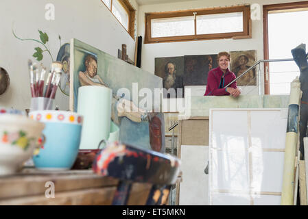 Porträt einer Künstlerin lächelnd in ihrem Studio, Bayern, Deutschland Stockfoto