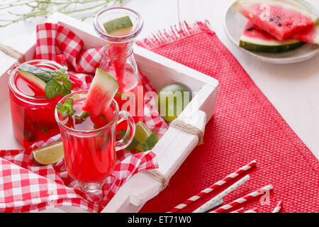 Wassermelone-Cocktails. Frisch zubereitete Wassermelone Cocktails und Stücke Melone auf ein rustikales Holztablett. Makro, Tiefenschärfe, Stockfoto