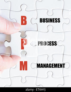 Hand eines Geschäftsmannes, die Vollendung des Puzzles mit das letzte fehlende Stück. Konzept-Bild des Business Abkürzung BMP als Business Process Management Stockfoto