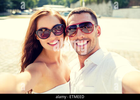 lächelnde paar Sonnenbrille Selfie machen Stockfoto