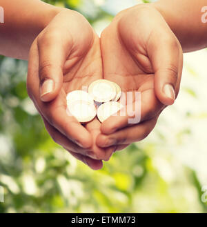 Womans schalenförmige Hände mit Euro-Münzen Stockfoto
