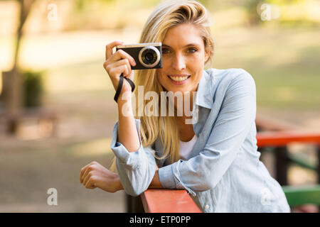 schöne blonde Frau, die das Fotografieren in der Natur Stockfoto