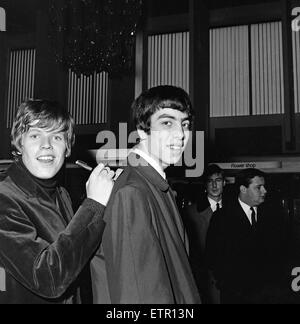 Peter Noone, Lead-Sänger der britischen Popgruppe Herman Hermits abgebildet ausstellen eines Schecks auf der Schulter von Graham Gouldman nach seiner Ankunft am Flughafen von Manchester nach einer Weltreise. Peter musste leihen das Häkchen, um Zölle auf einige Geschenke zu bezahlen, die er nach Hause gebracht hatte. 2. März 1966. Stockfoto