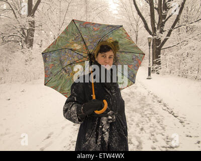 Frau allein durchschreitet Prospect Park bei nassem Schneesturm, Brooklyn, NY. Stockfoto