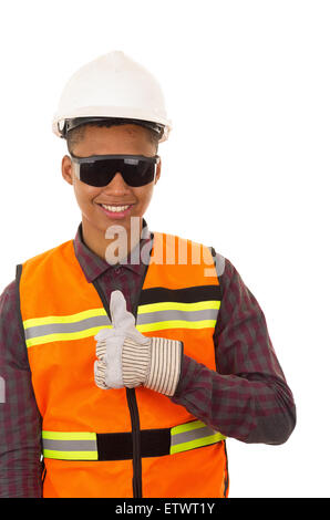 Hispanische Industrie Arbeiter mit Helm, Handschuhe und Neon Weste gibt Daumen bis zu Kamera Stockfoto