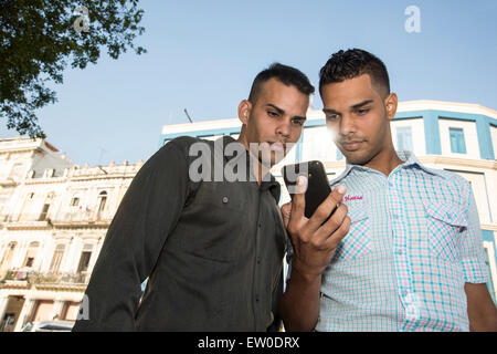 Zwei Latino Freunde mit Handy im freien Stockfoto