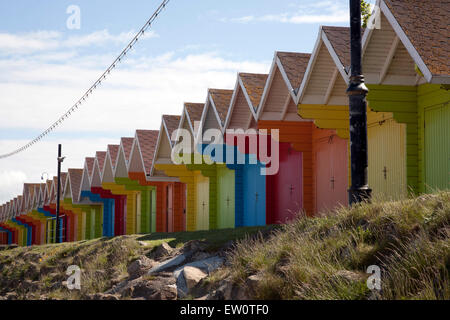 Reihe von bunten Strandhäuschen entlang der Strandpromenade, North Bay Scarborough, Yorkshire Stockfoto