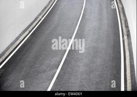 Industrielle Schuss mit einer neuen Asphalt zweispurige Straße, die aus einem tunnel Stockfoto