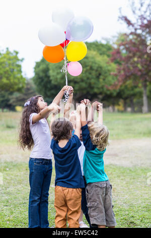 Glückliche Kinder mit Luftballons Stockfoto