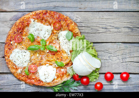 Pizza auf alten Vintage retro Holzbrettern mit Gewürzen Stockfoto