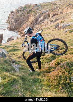Radfahrer tragen Ihr Fahrrad an der galizischen Küste. Der Mann ist in einer schönen Einstellung und Praxis Mountainbike. Stockfoto