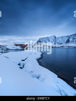 Traditionelle rote Meer Rorbu Kabinen im Winter, Toppøy, Reine Moskenesøy, Lofoten Inseln, Norwegen Stockfoto