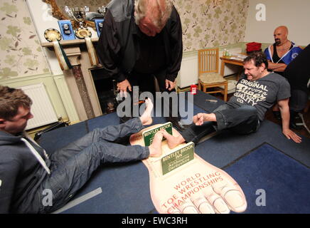 Die Teilnehmer kämpfen bei den Toe Wrestling Weltmeisterschaften bei Fenny Bentley in Derbyshire, England Stockfoto