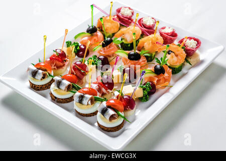 Platte mit verschiedenen Fisch- und Fleisch-Häppchen Stockfoto