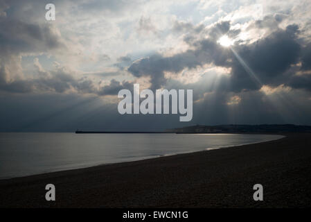 Sonnen-Strahlen durch Wolke über ruhige See und leeren Strand, Seaford, Sussex Stockfoto