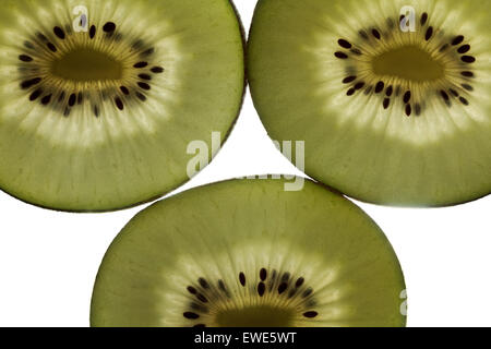 Drei beleuchtete zurück Scheiben von golden kiwi Stockfoto