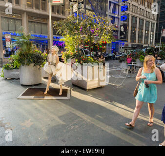 Menschen weitergeben Forever Marilyn vom Künstler Seward Johnson auf dem Broadway Fußgängerzone Plätze im Garment District in New York Montag, 22. Juni 2015. Achtzehn Jahren gemalt lebensgroße Bronze-Skulpturen von Johnson Gnade die Plazas, einige der berühmten Fotos und andere alltägliche Menschen alltägliche Dinge zu tun. Die Ausstellung wird bis zum 15. September sein. (© Richard B. Levine) Stockfoto