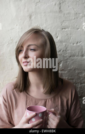 Schöne junge Frau trinken Kaffee wegschauen Stockfoto