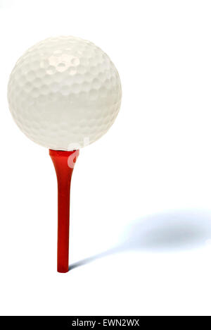 Golfball auf einem roten Holz t-Shirt auf weißem Hintergrund mit einem Schatten zeigt Tiefe Stockfoto