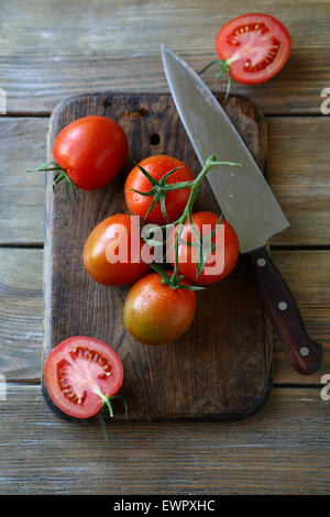 Tomaten auf dem alten Schneidebrett, Lebensmittel-Draufsicht Stockfoto