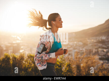 Porträt der schönen jungen Frau, für einen Lauf an einem heißen sonnigen Tag. Kaukasische weibliches Modell Joggen im Freien. Stockfoto