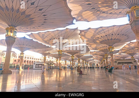 MEDINA, Saudi-Arabien - 6. März 2015: Pilger Fuß unter Riesenschirme auf Nabawi Moschee-Gelände. Stockfoto