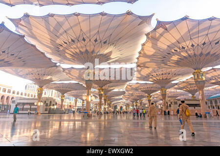 MEDINA, Saudi-Arabien - 6. März 2015: Pilger Fuß unter Riesenschirme auf Nabawi Moschee-Gelände. Stockfoto