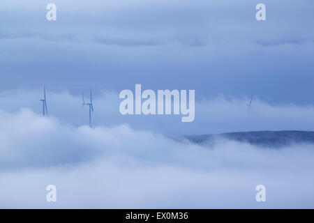 Windkraftanlagen stoßen durch Nebel am Rande des Stiperden Moor in der südlichen Pennines, in der Nähe von Burnley, Lancashire, UK Stockfoto