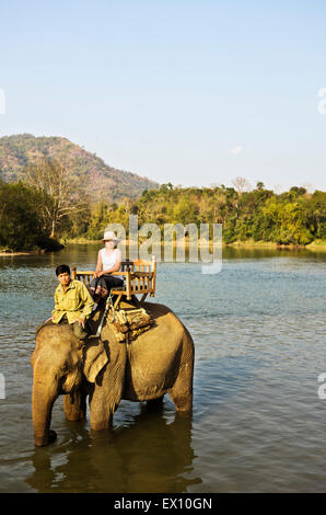 Lao Frau und Mahout Elefantenritt ein auf dem Khan Fluss. Luang Prabang, Laos. Stockfoto