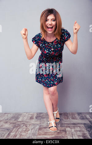 In voller Länge Portrait von eine erfolgreiche fröhliche Frau im studio Stockfoto