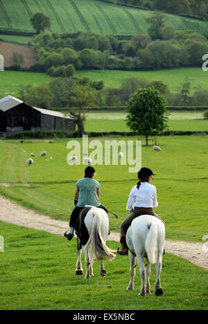 Zwei Dame Reiter auf einem Pferd Reiten-Urlaub in der Nähe von Winchcombe in den Cotswolds, Gloucestershire UK Stockfoto