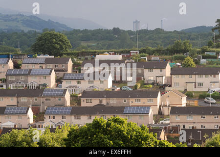Lichtdurchfluteten Wohnraum mit solar Verkleidung auf den Dächern im Bereich Bettws Stadt Newport, Wales, Cwmbran in der Ferne sehen. Stockfoto
