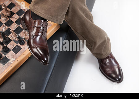 Mann Männer Menschen Hose Hose Schach Schach-Man Schach-Männer Studio spielen Spiel isoliert Hintergrund Möbel Sessel sitzen Stockfoto