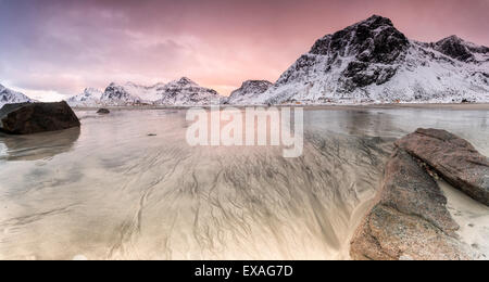 Sonnenuntergang am surreale Skagsanden Strand umgeben von Schnee bedeckt Berge, Flakstad, Lofoten-Inseln, Arktis, Norwegen Stockfoto