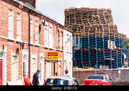 Belfast, Nordirland. 20. Juli 2015 - beginnen Einwohner aus der Gegend, eine massive Lagerfeuer nur Yards von Häusern in Cobham Street, East Belfast, auf ein Wanderweg, bekannt als "The Comber Greenway" zu bauen.  Häuser in der Gegend sind wird mit Brettern vernagelt, um sie zu schützen, aber es besteht die Gefahr, die Häuser werden beschädigt, wenn es am Samstag Abend beleuchtet ist. Bildnachweis: Stephen Barnes/Alamy Live-Nachrichten Stockfoto