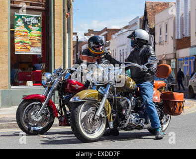 Zwei Motorradfahrer fahren Harley Davidson Motorräder in Salisbury sprechen miteinander, während an der Ampel angehalten. Stockfoto