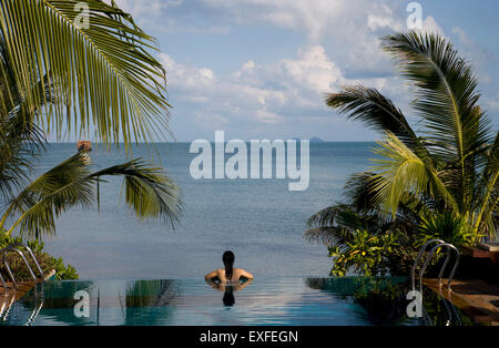 Ansicht von hinten Mitte erwachsenen Frau entspannend im Infinity-Pool, Koh Samui, Thailand Stockfoto