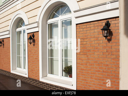 zwei weiße Kunststoff-Fenster in einer Mauer außerhalb Stockfoto