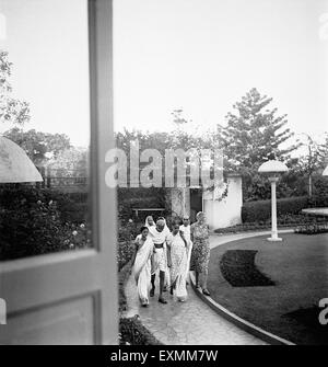 Mahatma Gandhi; unterstützt von Abha Gandhi und anderen zu Fuß in der Birla House; Mumbai; 1945 Pyarelal Nayar Agatha Harrison Stockfoto