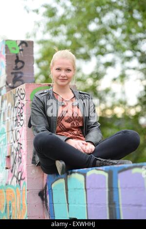 Junge Frau bei einer Graffiti-Wand, Nürnberg, Bayern, Deutschland, Europa Stockfoto