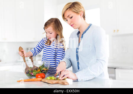 Mutter und Tochter (4-5) Salat vorbereiten Stockfoto