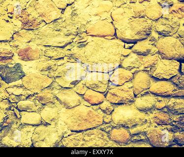 Vintage Foto der Hintergrund der Steinmauer Textur. Alte Gebäudewand mit Vintage Stimmung Stockfoto