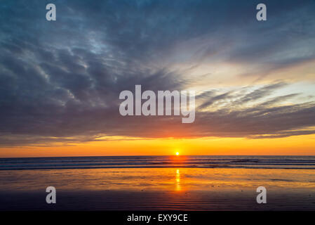 Farbenprächtigen Sonnenuntergang und dramatischer Himmel am Strand von Montanita, Ecuador Stockfoto