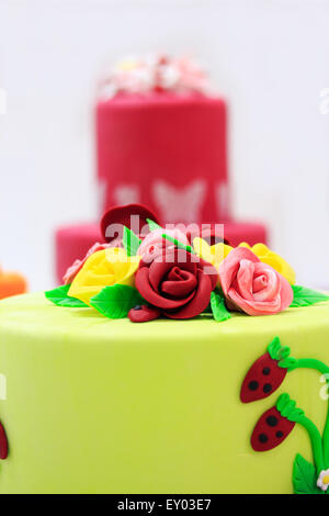 Kuchen mit künstlichen Blumen und Beeren dekoriert. Stockfoto