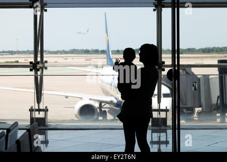 Mutter und Kind am Flughafen beobachten Flugzeuge - Konzept - mit Kindern, Babys; Flughafen El Prat, Barcelona-Spanien-Europa Stockfoto