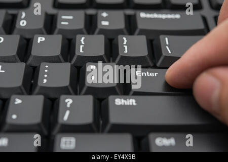 drücken die Enter-Taste einer schwarzen Tastatur Stockfoto