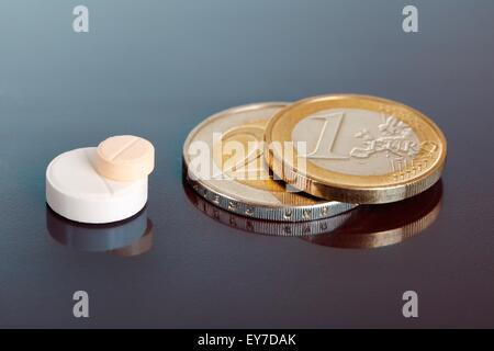 Closeup auf paar gestapelte Pillen in der Nähe von ähnlich angeordneten Euro-Münzen Stockfoto