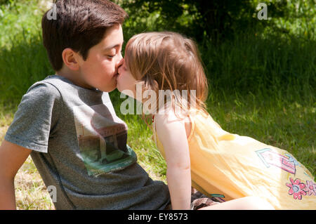 Kleines Mädchen, ein Junge küssen Stockfoto