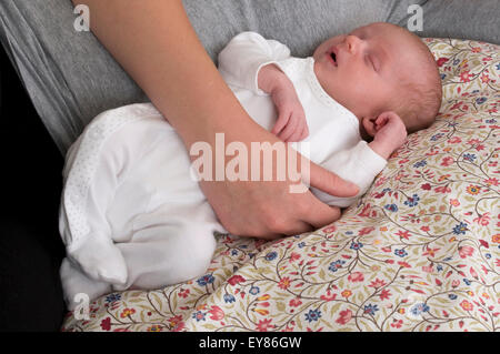 Neugeborenes Babymädchen neben ihrer Mutter schlafen hinlegen Stockfoto
